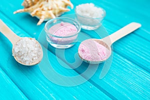 Sea Ã¢â¬â¹Ã¢â¬â¹salt in a glass white stones and Shell for spa and relaxation on a blue background